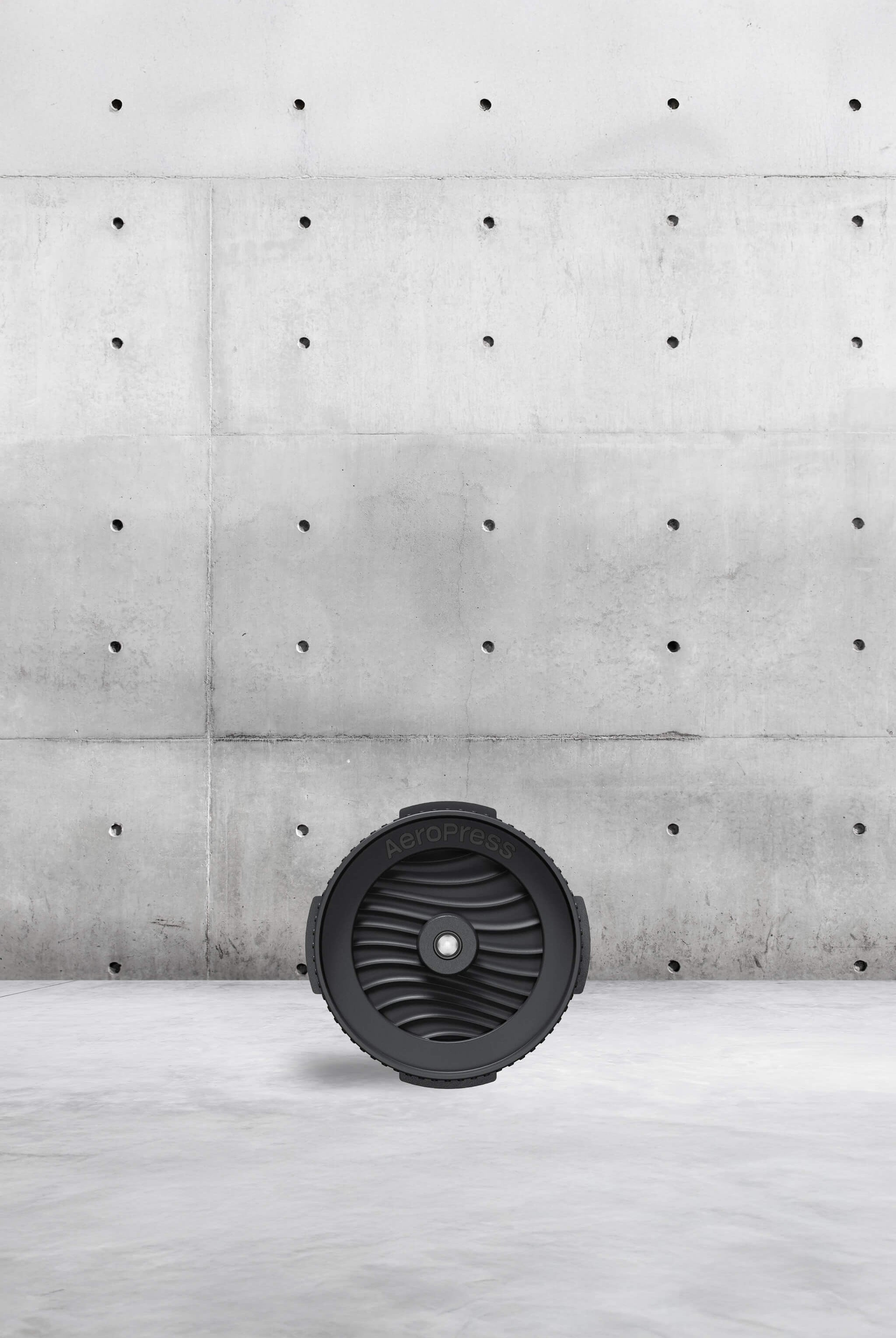 Black cap on a light grey surface