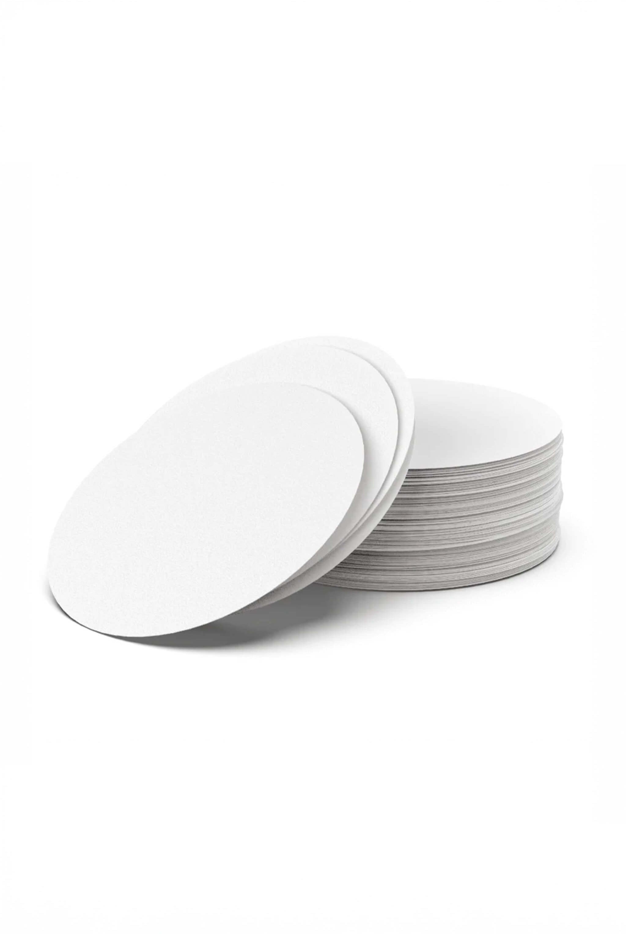 Stack of white round paper filters on a white background