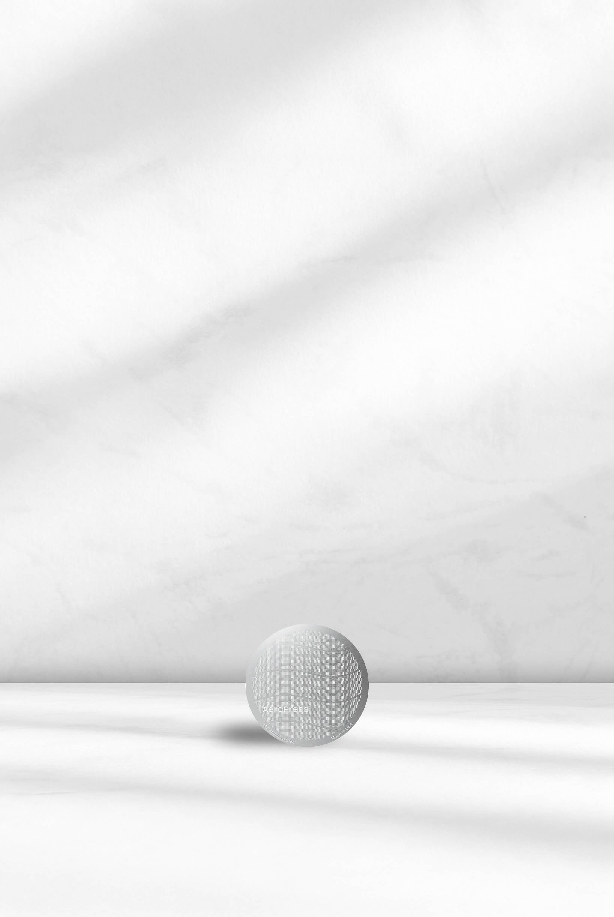 Aeropress Stainless Steel filter on a white background