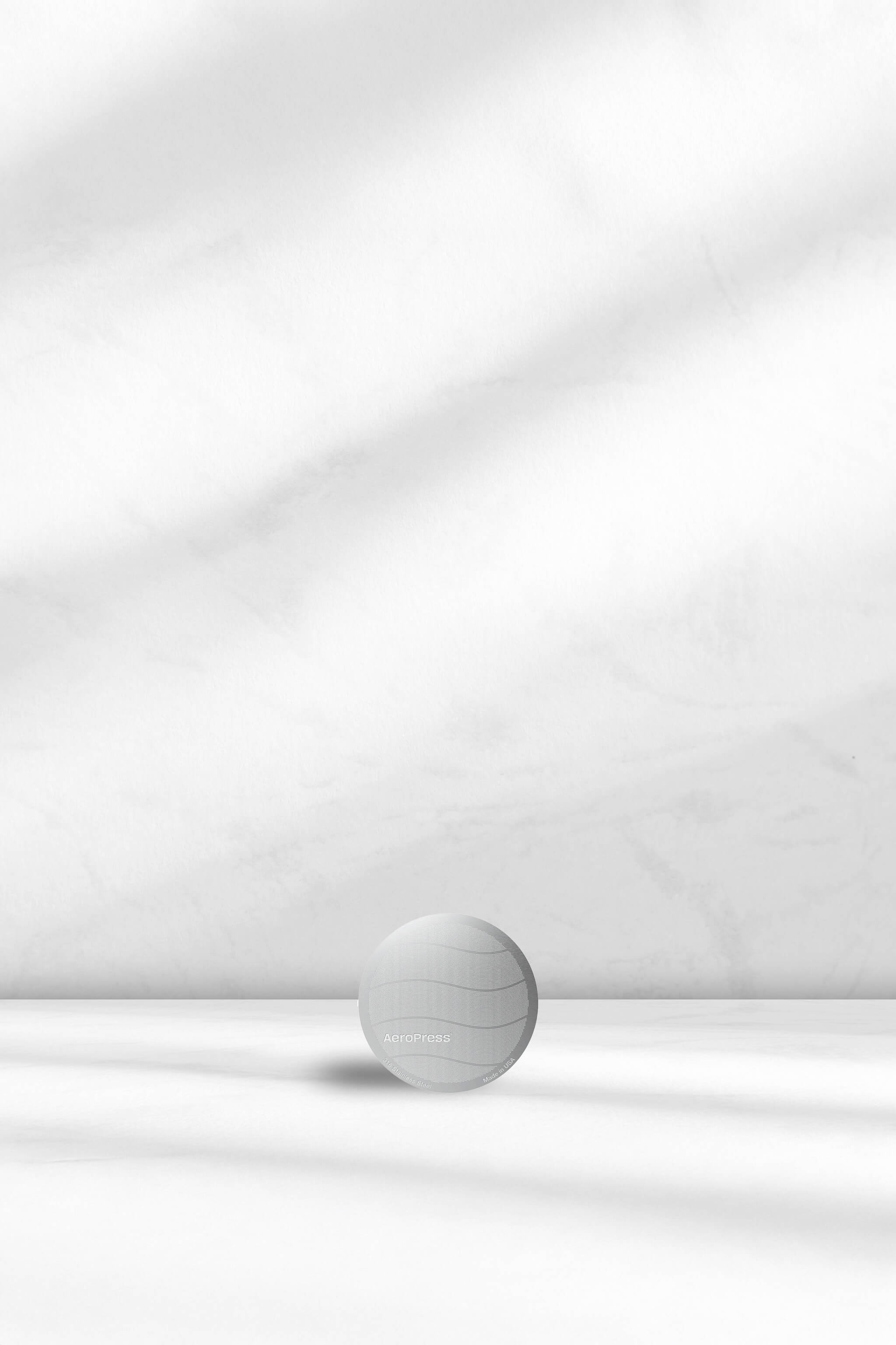 Aeropress Stainless Steel filter on a white background