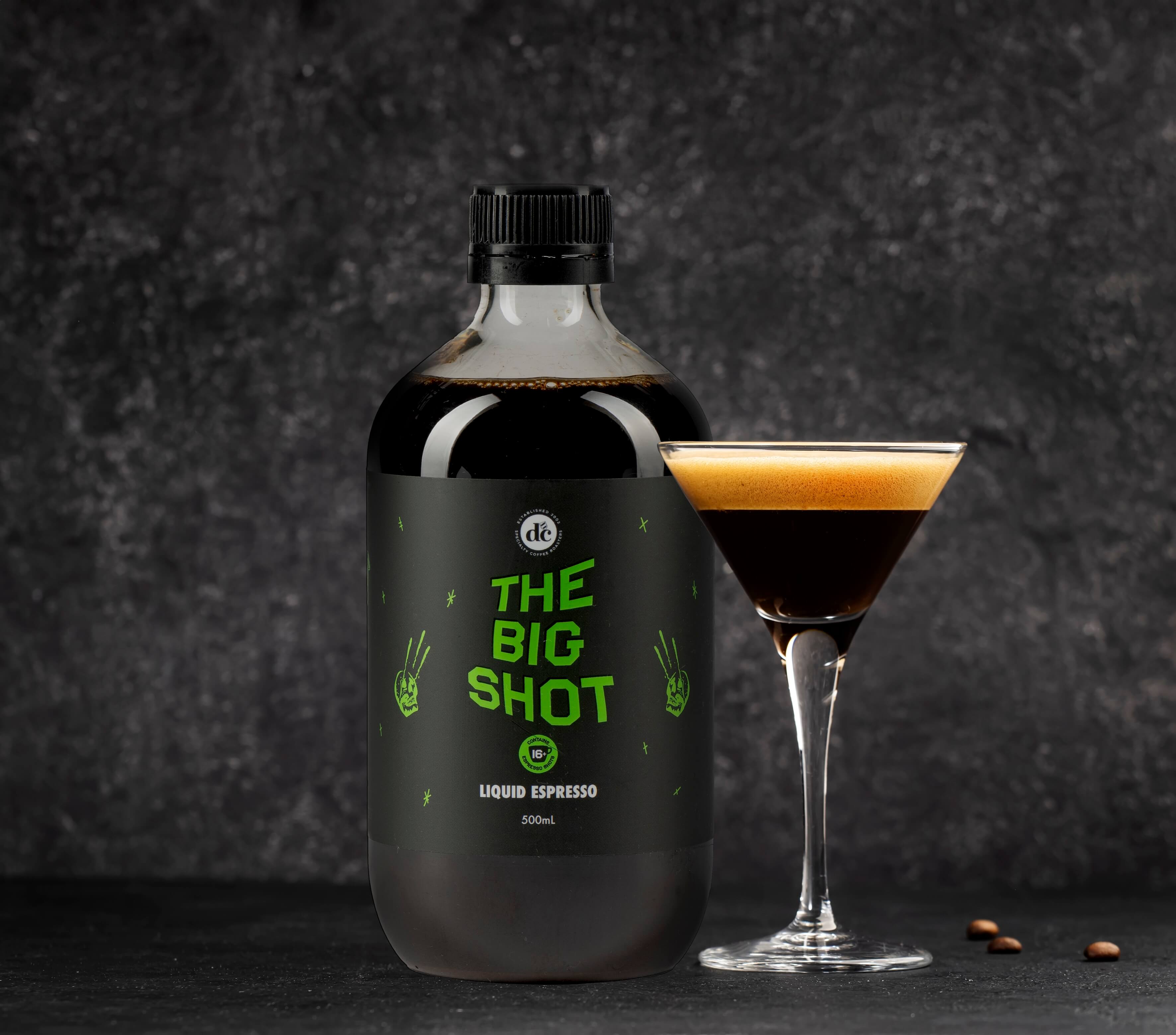 Bottle of coffee extract next to espresso martini