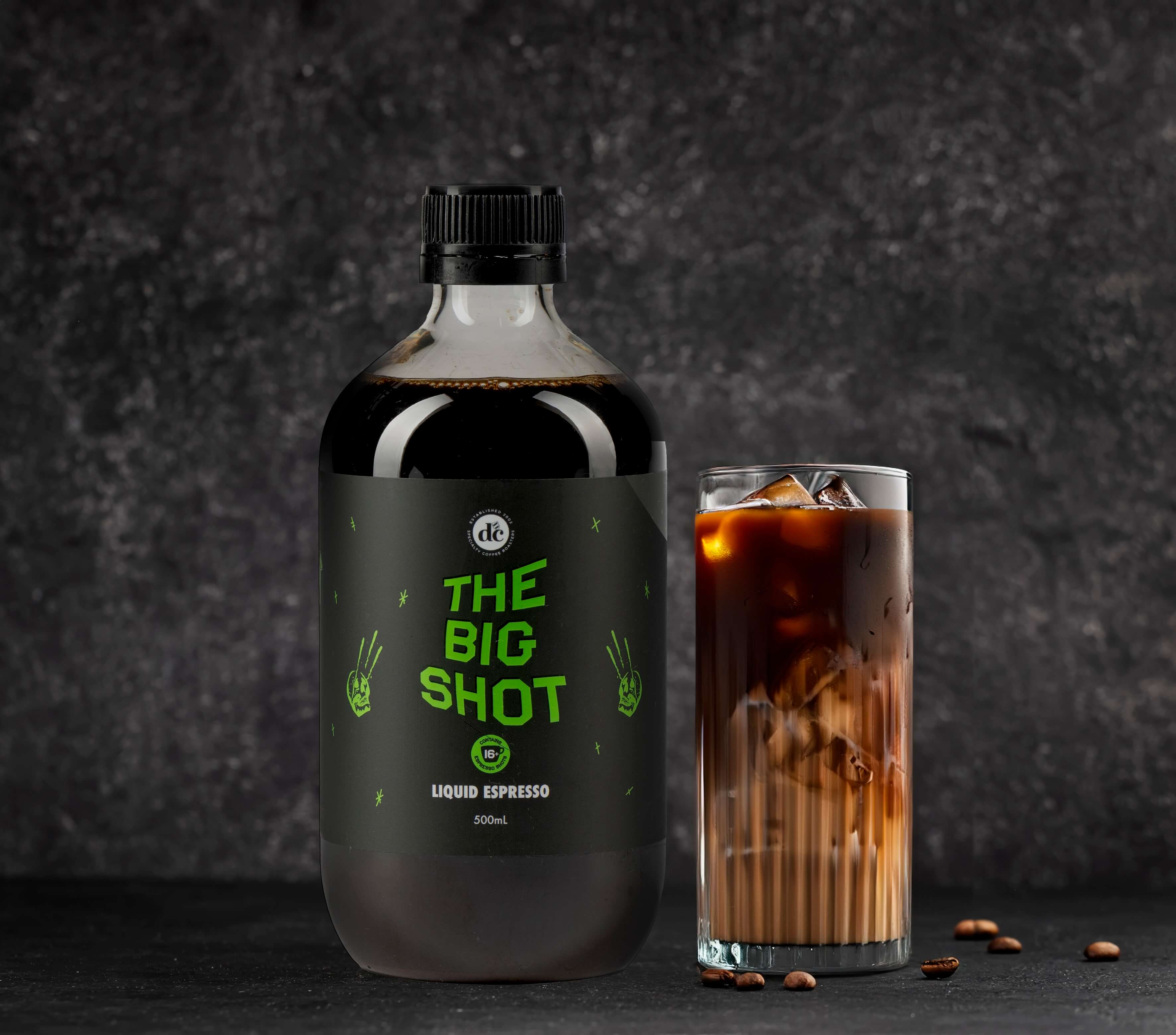 Bottle of coffee extract next to iced coffee