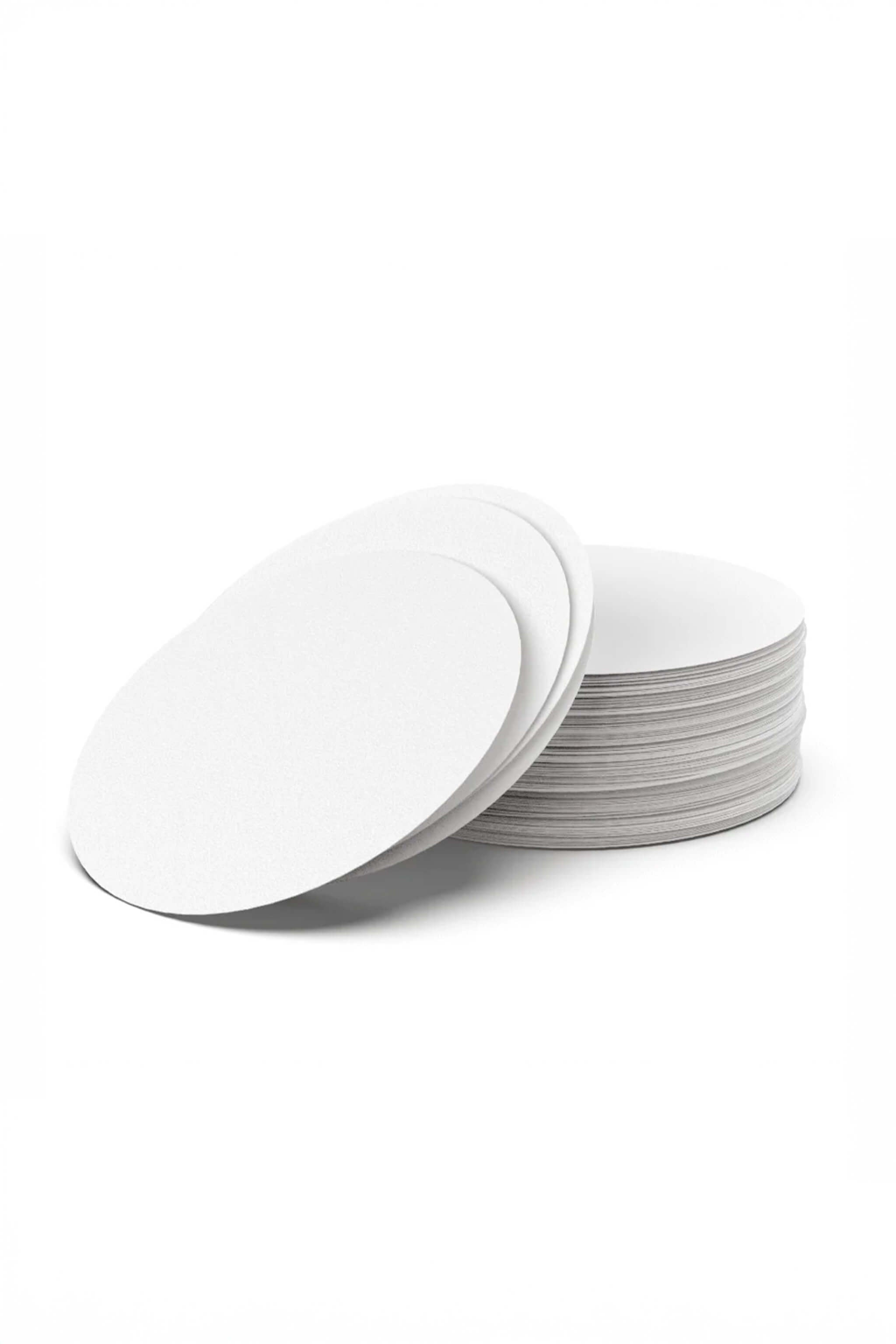 Stack of white round paper filters on a white background