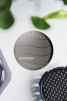 Aeropress Reusable Stainless Steel Coffee Filter on white surface