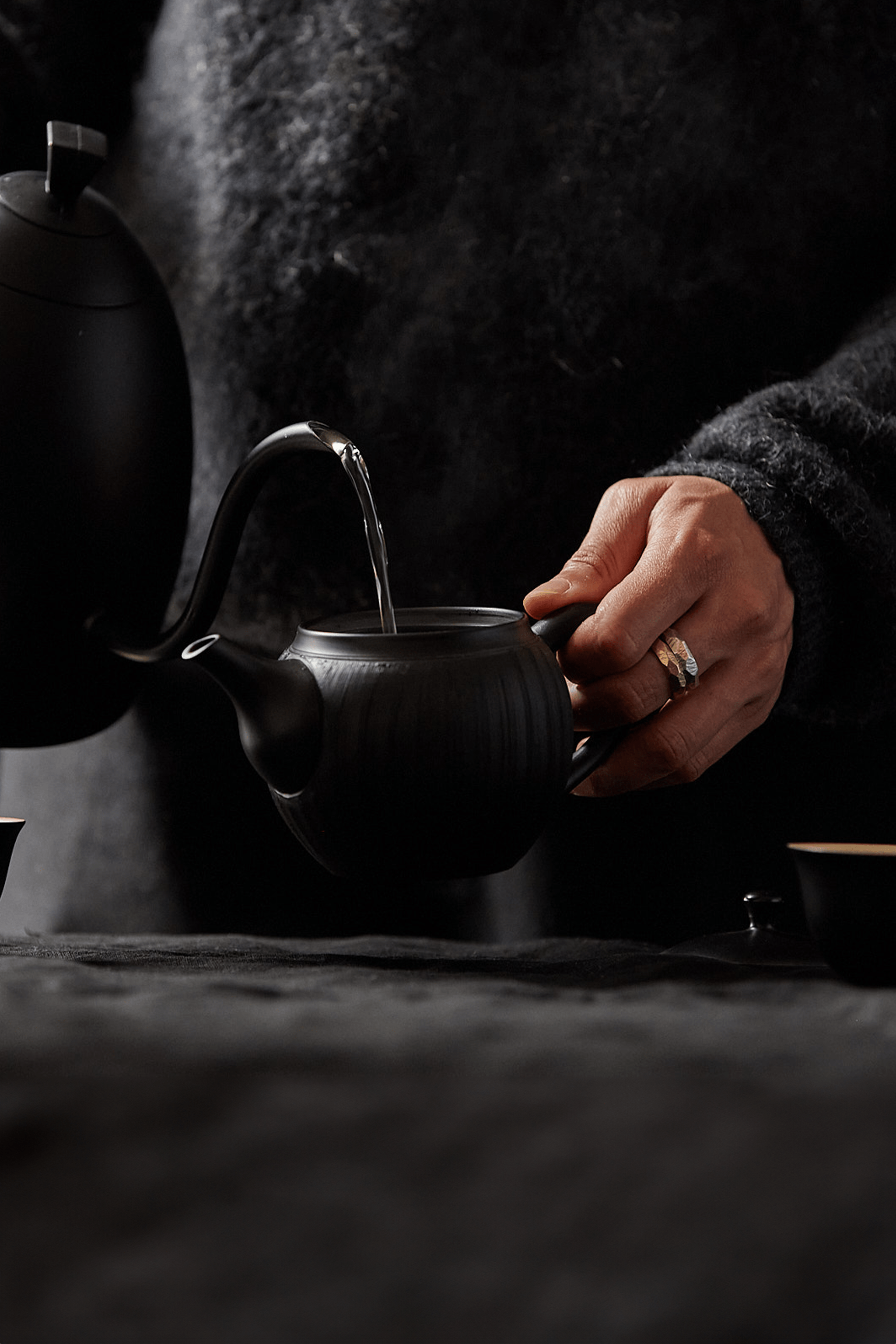 Kettle pouring water into a tea pot