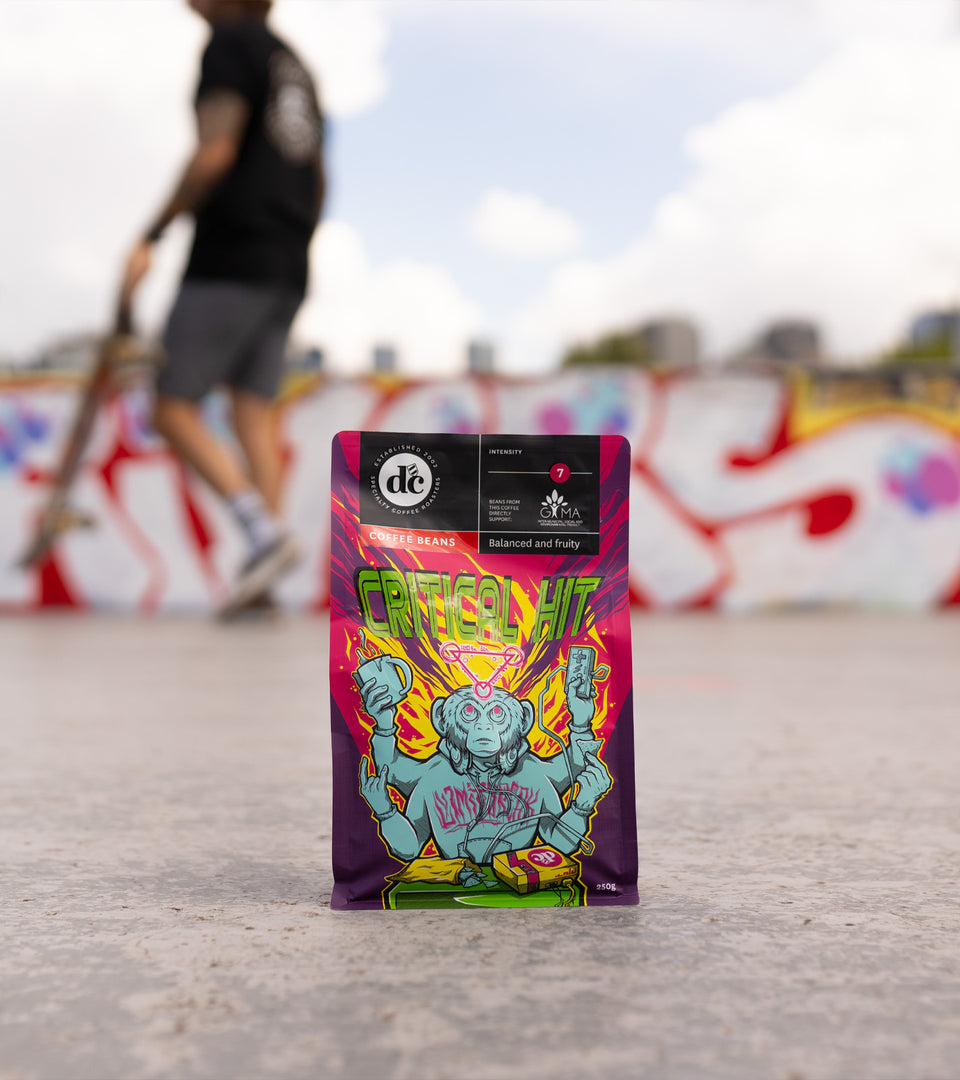 DC Coffee Critical Hit blend sitting on ground at skatepark