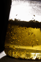 Tea leaves infusing in a glass pot