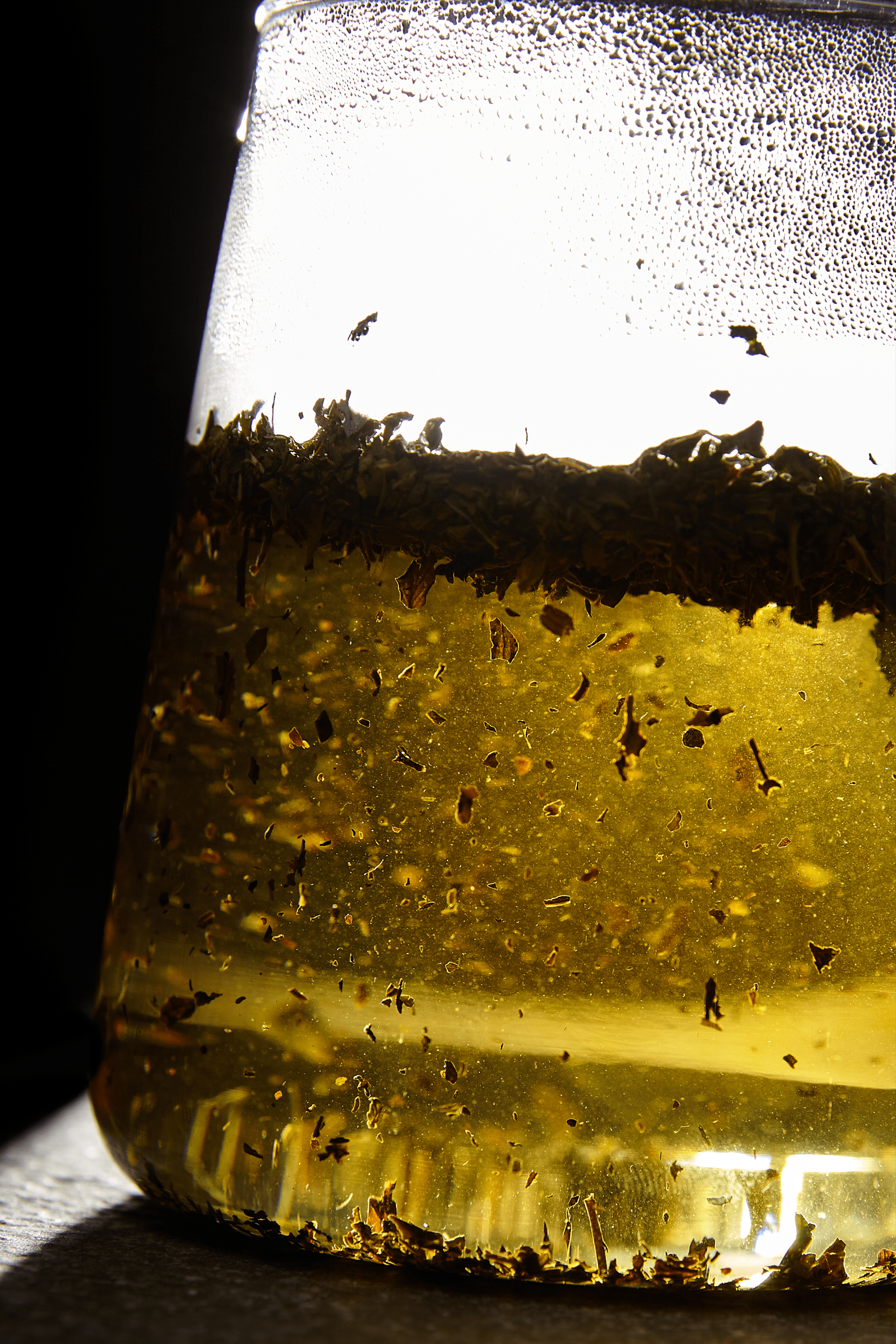 Tea leaves infusing in a glass pot