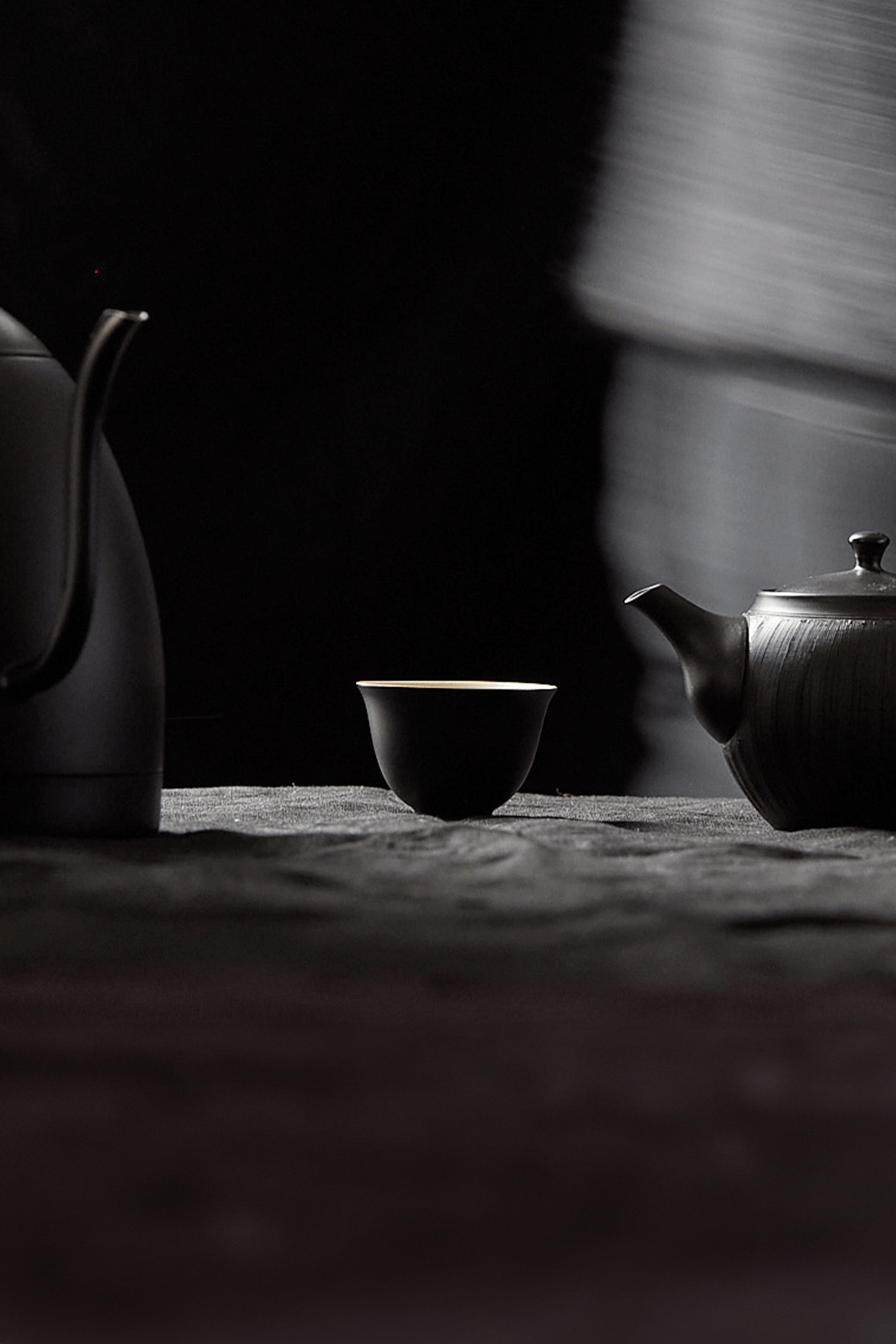 Teapot, kettle and cup on table