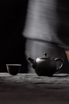 Teapot and cup on table