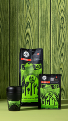 The Darkness Reusable KeepCup with Darkness coffee beans bags against green wooden background